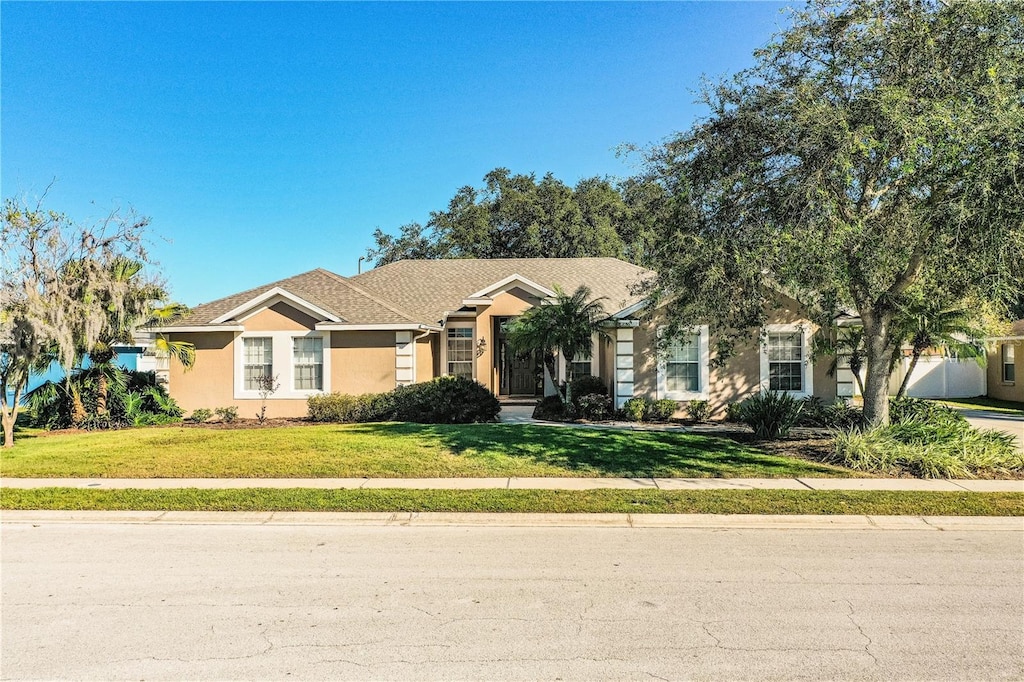 ranch-style home featuring a front yard