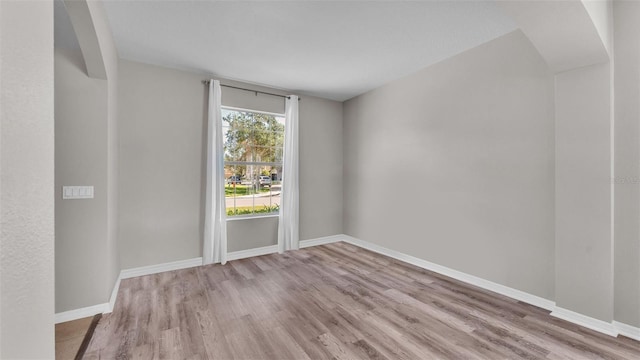 unfurnished room with light hardwood / wood-style floors