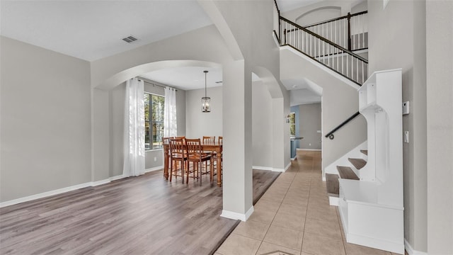 tiled entryway with a high ceiling