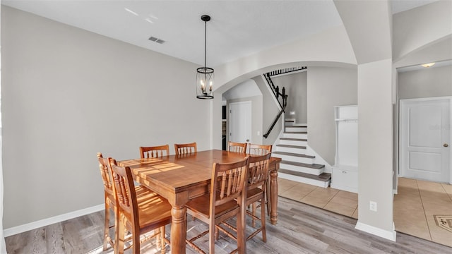 dining space with a chandelier and light hardwood / wood-style flooring