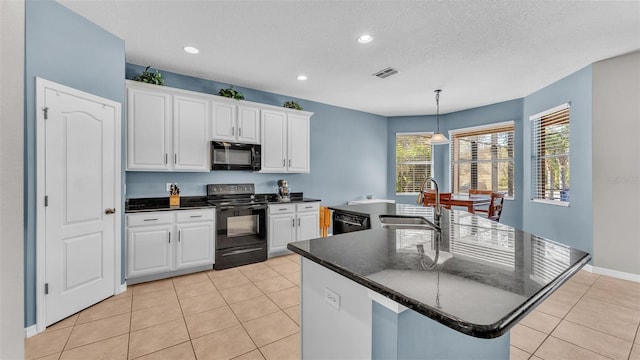 kitchen featuring black appliances, white cabinetry, sink, and a kitchen island with sink