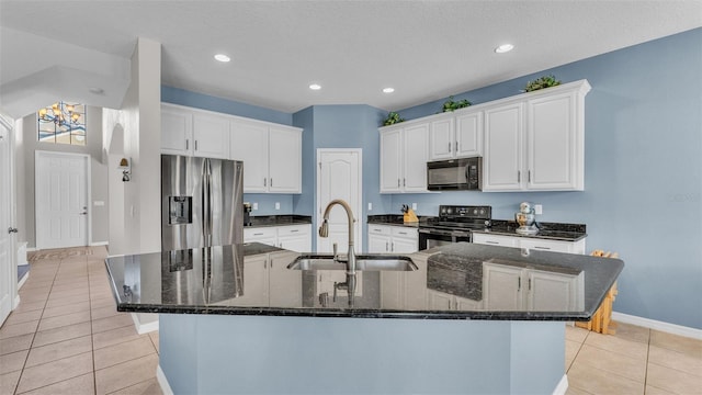 kitchen featuring white cabinetry, a large island, sink, light tile patterned flooring, and black appliances