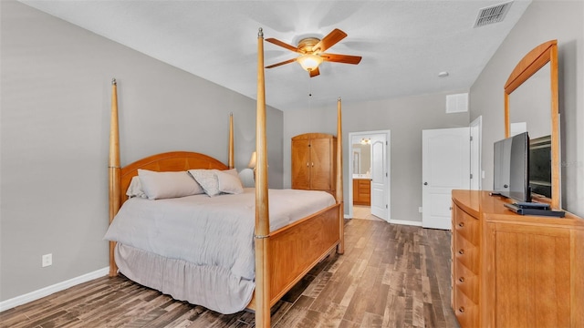 bedroom featuring ensuite bath, ceiling fan, and dark wood-type flooring