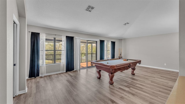 rec room with a textured ceiling, light hardwood / wood-style flooring, lofted ceiling, and pool table