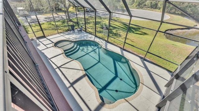 view of pool featuring a lawn and glass enclosure