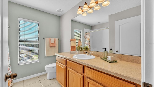 bathroom featuring tile patterned flooring, vanity, curtained shower, and toilet