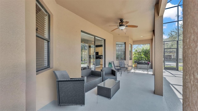 view of patio / terrace featuring glass enclosure and ceiling fan