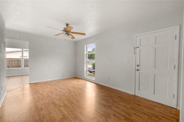 unfurnished room featuring light wood-type flooring and ceiling fan