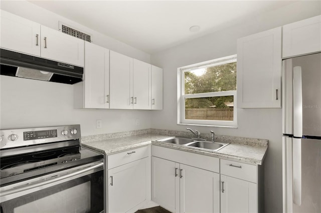 2473 Barbarossa, Deltona, FL 32738 - kitchen featuring appliances with stainless steel finishes, under cabinet range hood, white cabinetry, and light countertops
