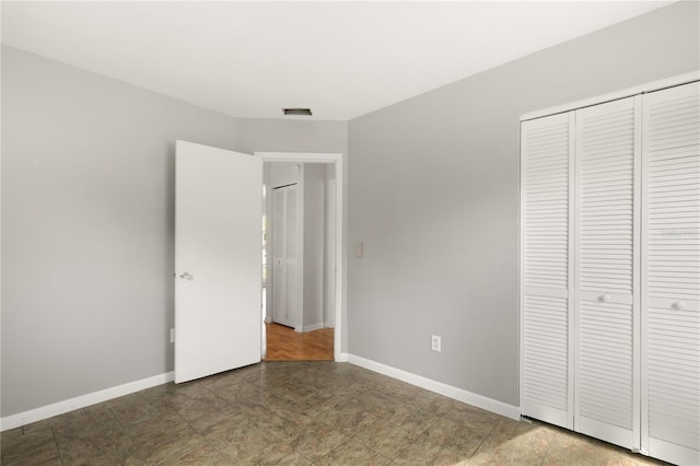 unfurnished bedroom with a closet