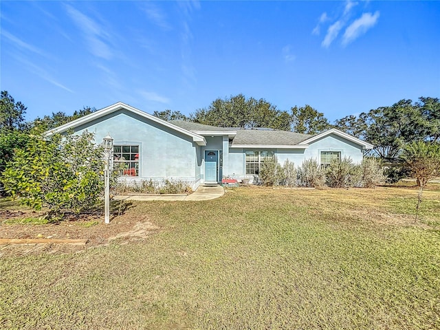 single story home with a front lawn