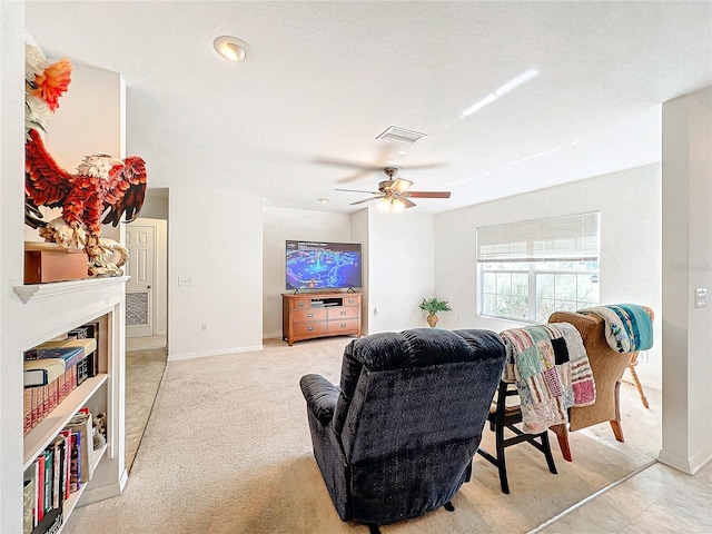 carpeted living room with ceiling fan