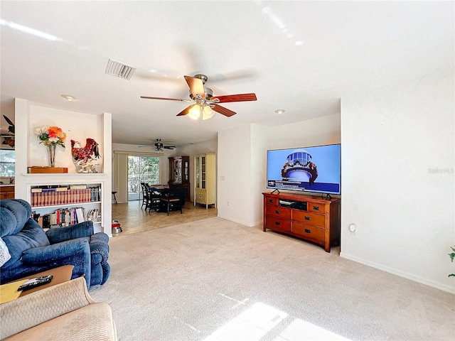 living room with light carpet and ceiling fan