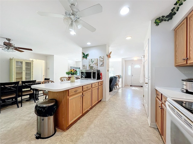 kitchen with ceiling fan and white range