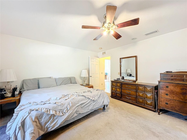 bedroom featuring light carpet and ceiling fan