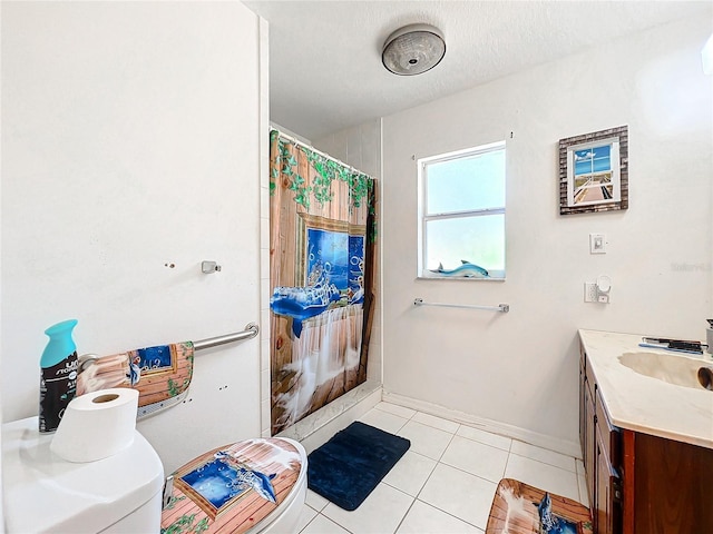 bathroom with tile patterned floors, vanity, and a textured ceiling