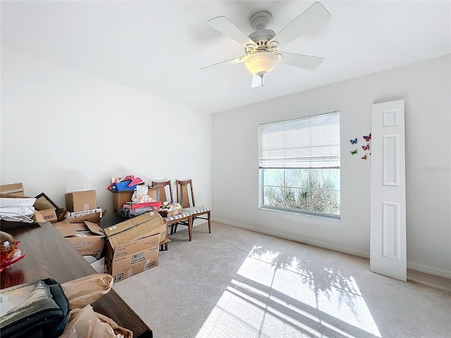 interior space with ceiling fan and light carpet