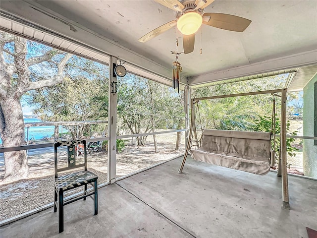 unfurnished sunroom with ceiling fan and a healthy amount of sunlight