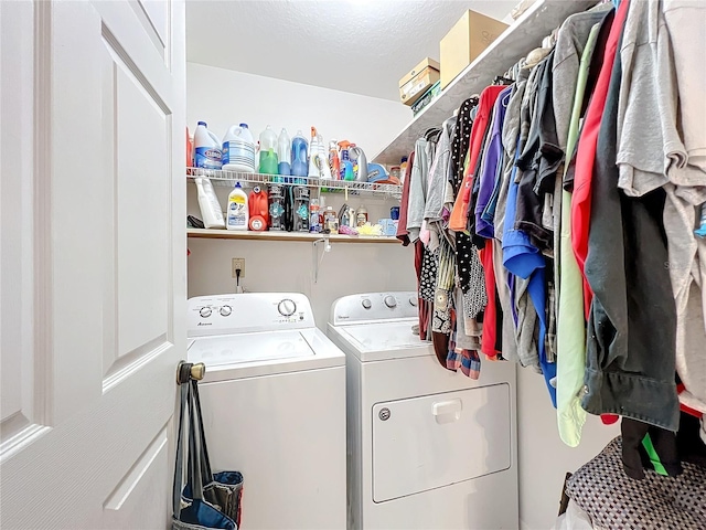 laundry room featuring separate washer and dryer and a textured ceiling