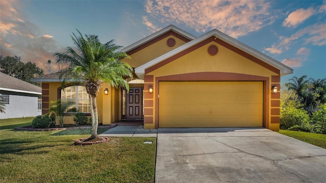 ranch-style home with a yard and a garage