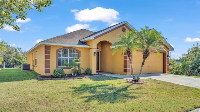 view of front of property featuring central AC unit, a garage, and a front lawn