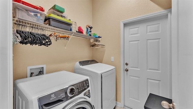 clothes washing area featuring washing machine and dryer