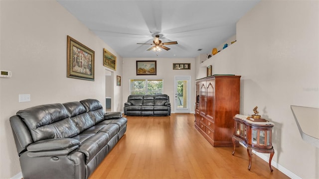 living room featuring ceiling fan and light hardwood / wood-style floors