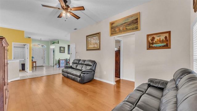 living room with light hardwood / wood-style floors and ceiling fan