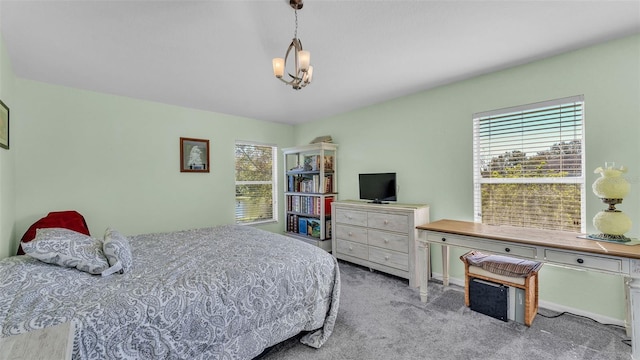 carpeted bedroom with a notable chandelier