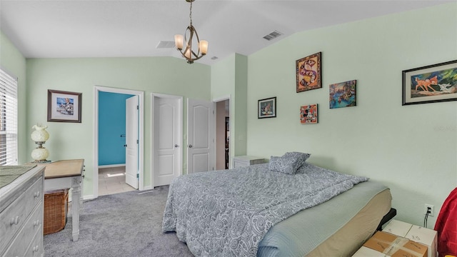 bedroom featuring ensuite bathroom, light colored carpet, lofted ceiling, and a notable chandelier