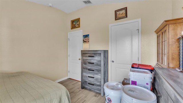 bedroom with lofted ceiling and light hardwood / wood-style flooring