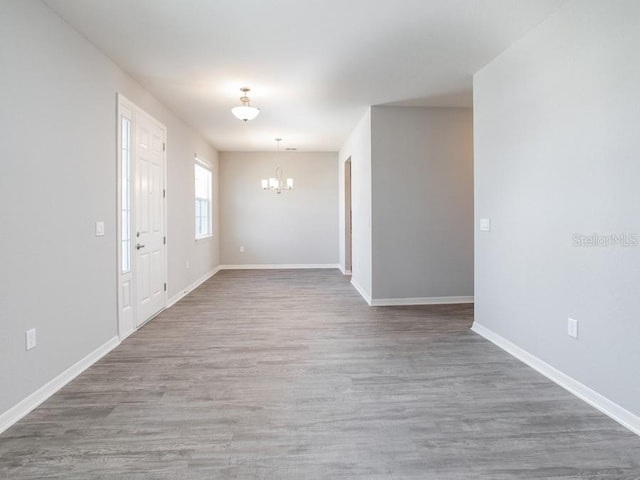 interior space featuring a chandelier and wood-type flooring