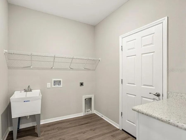 washroom featuring laundry area, wood finished floors, baseboards, electric dryer hookup, and washer hookup