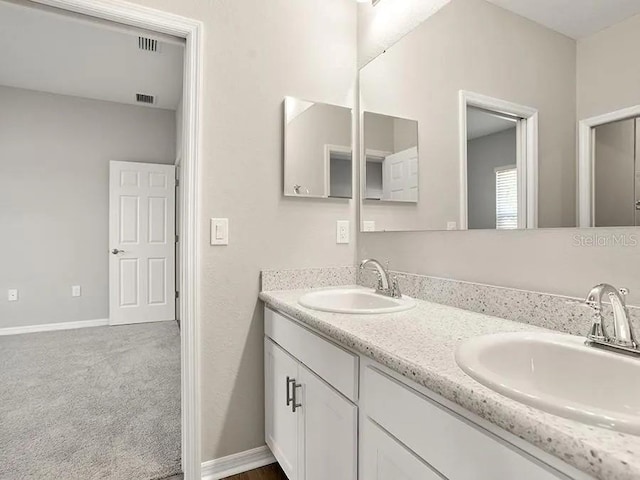 full bathroom featuring a sink, visible vents, and double vanity