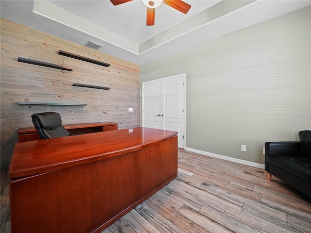 home office with ceiling fan and light hardwood / wood-style floors