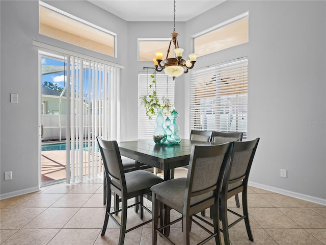 tiled dining space featuring an inviting chandelier and a wealth of natural light