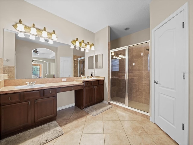 bathroom with tile patterned flooring, ceiling fan, a shower with door, and vanity