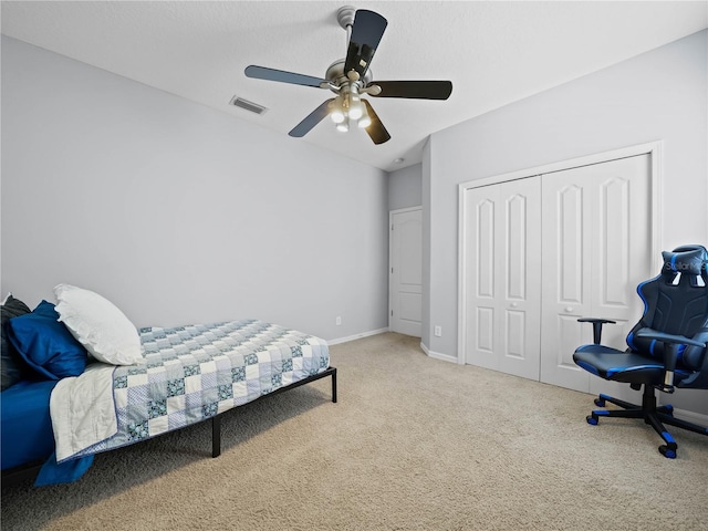 carpeted bedroom with ceiling fan and a closet