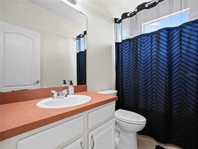 bathroom featuring tile patterned floors, vanity, a shower with shower curtain, and toilet