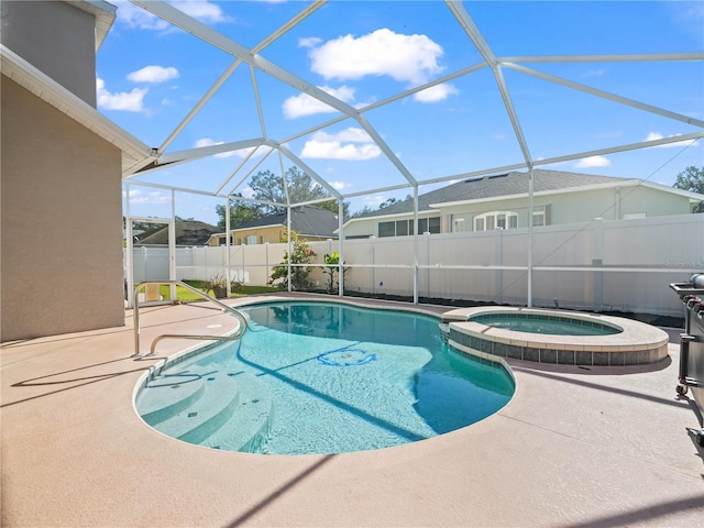 view of pool with a lanai, an in ground hot tub, and a patio