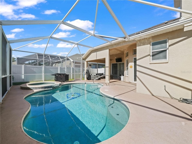 view of pool with an in ground hot tub, a lanai, and a patio area