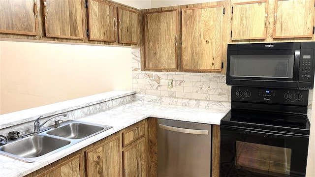 kitchen with black appliances, backsplash, and sink