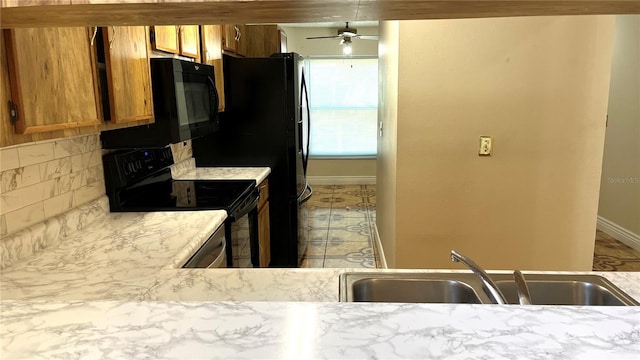 kitchen with backsplash, ceiling fan, stove, and sink