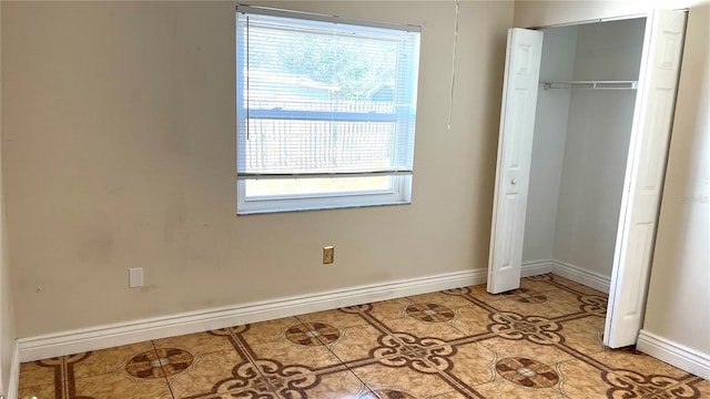 tiled bedroom with a closet and multiple windows