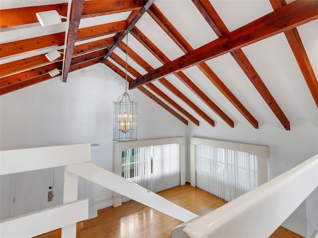 living room featuring a notable chandelier, beam ceiling, light wood-type flooring, and high vaulted ceiling