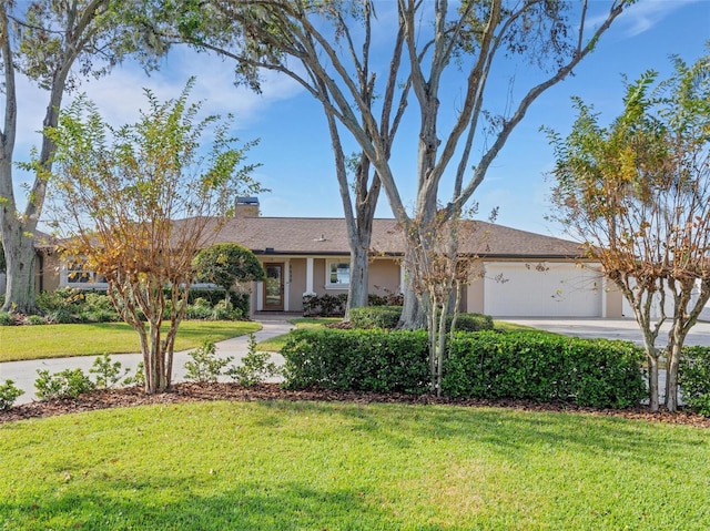 single story home featuring a garage and a front lawn