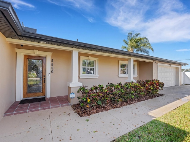 doorway to property with a garage