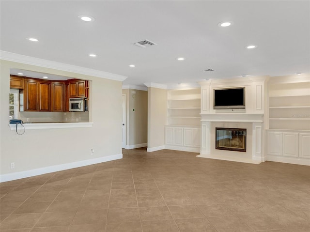 unfurnished living room with built in features, ornamental molding, and light tile patterned floors