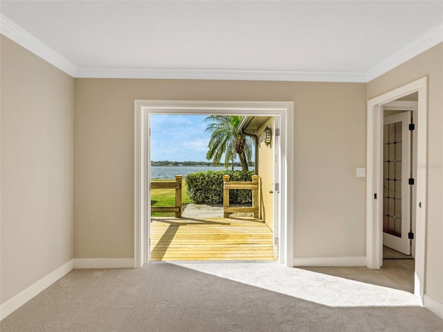 doorway to outside featuring light carpet, a water view, and ornamental molding