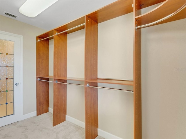 spacious closet featuring light carpet